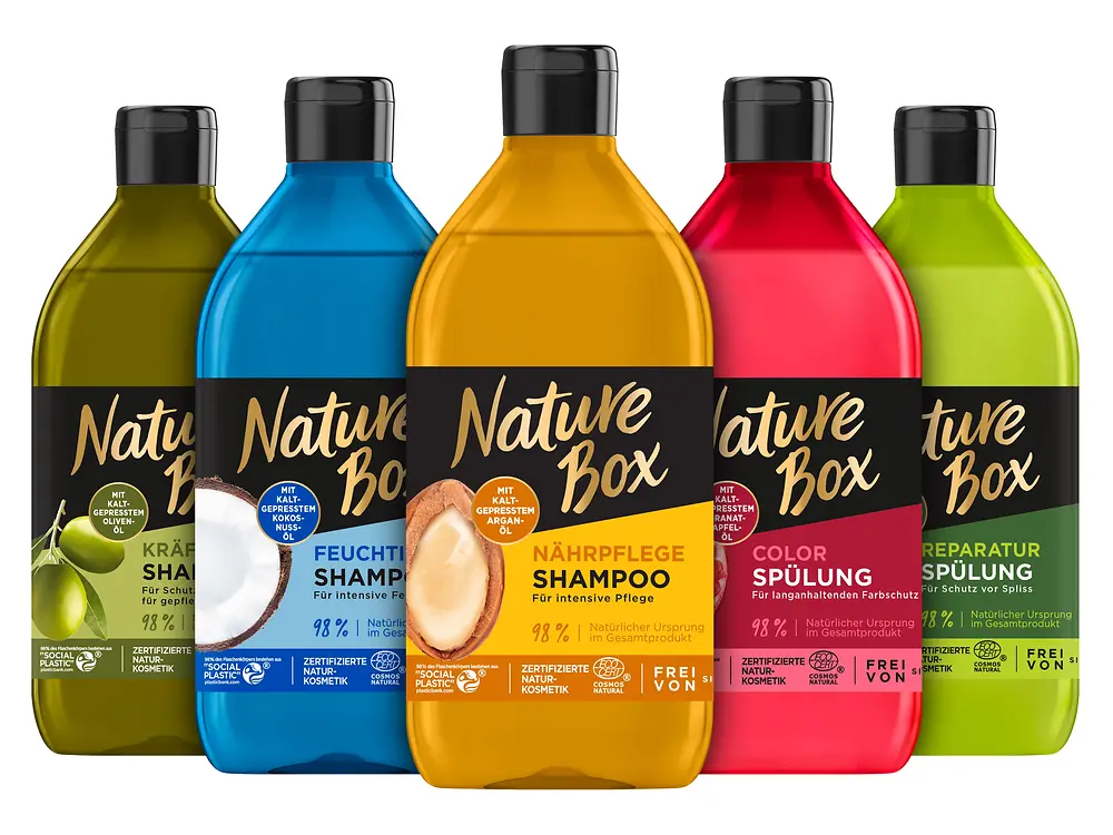 Fünf bunte Flaschen von Nature Box stehen nebeneinander.