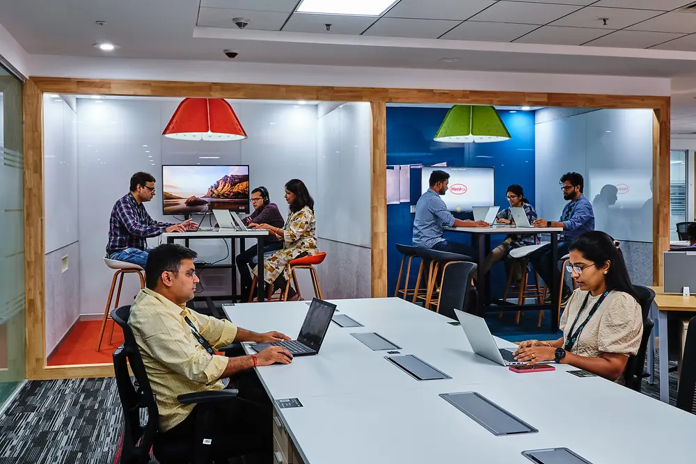 Mitarbeiter:innen des Global Technology Centers arbeiten in ihrem neuen Büro gemeinsam an digitalen Lösungen. 