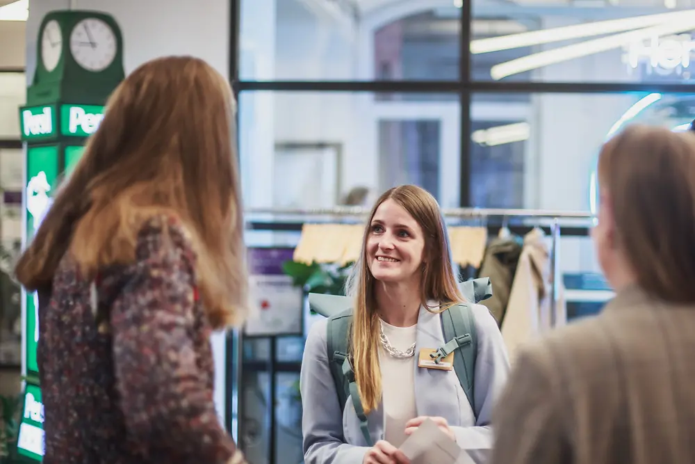 Three women are talking to each other. 