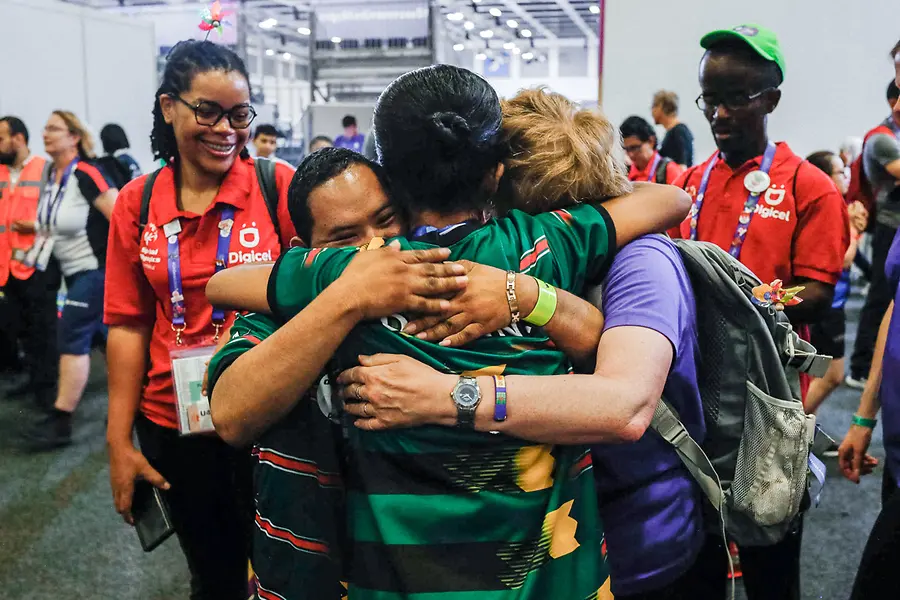 Drei Menschen umarmen sich innig bei den Special Olympics.