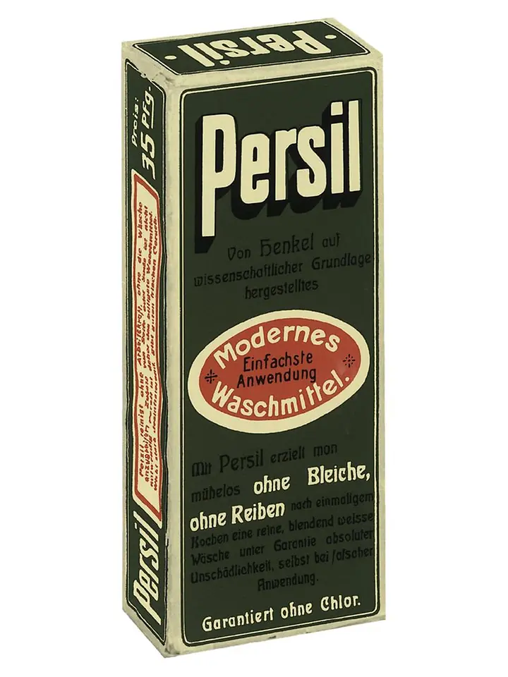 Grüne rechteckige Kartonverpackung des ersten Persil-Waschmittels aus dem Jahr 1907 mit der Aufschrift „Modernes Waschmittel“ und weißen Schriftzügen.
